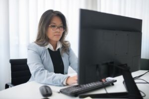 Profesional de RRHH trabajando con un sistema de nómina digital en el monitor